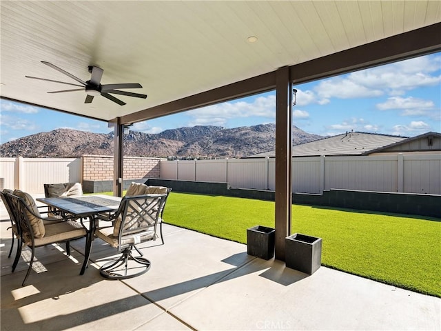 view of patio featuring a mountain view and ceiling fan