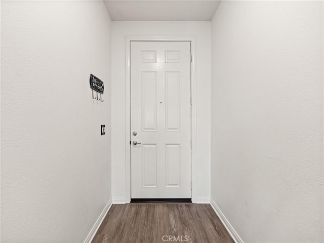 doorway with dark hardwood / wood-style flooring