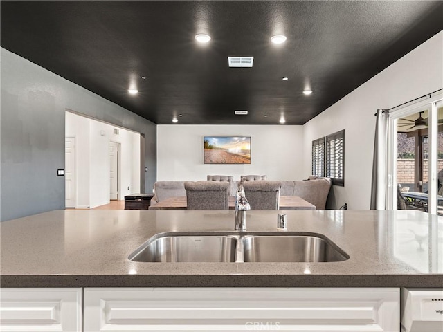 kitchen featuring sink and white cabinets