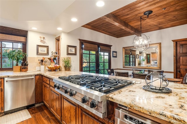 kitchen with hanging light fixtures, a notable chandelier, beam ceiling, wood ceiling, and stainless steel appliances