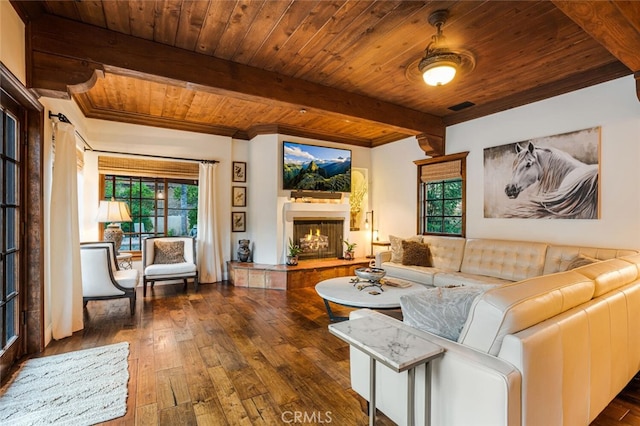 living room featuring dark wood-type flooring, a tile fireplace, ceiling fan, beam ceiling, and wood ceiling