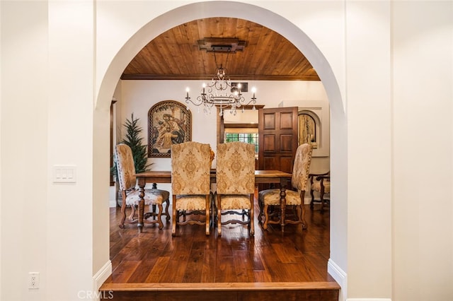 dining room featuring hardwood / wood-style flooring, wood ceiling, ornamental molding, and an inviting chandelier