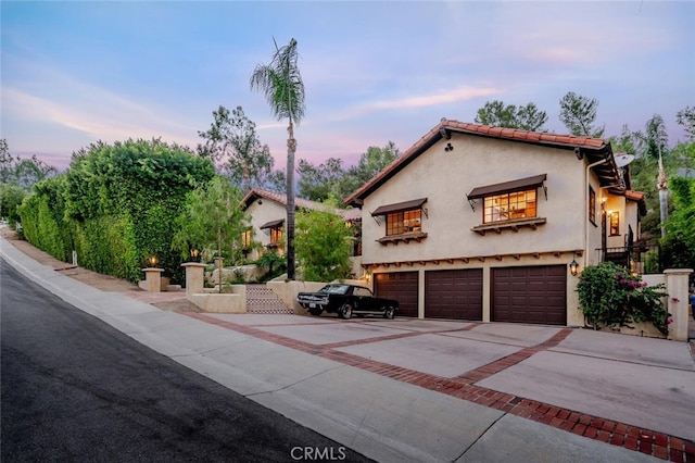 mediterranean / spanish house featuring a garage