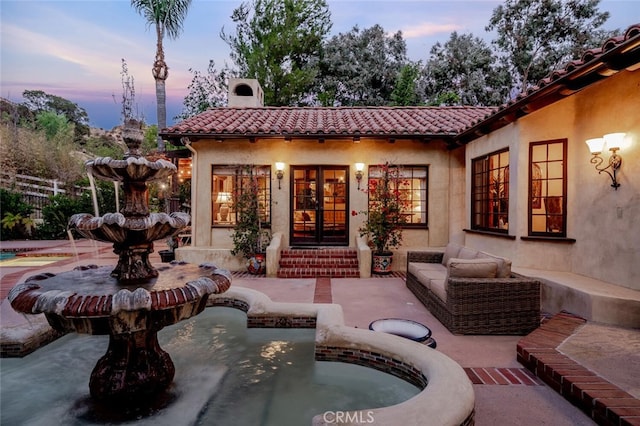 view of patio terrace at dusk