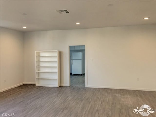 spare room featuring wood-type flooring