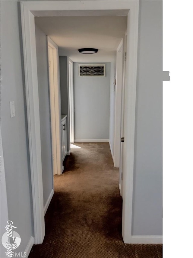 hallway with dark colored carpet