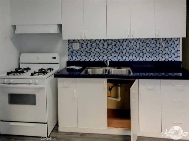 kitchen with tasteful backsplash, white cabinetry, white gas stove, and extractor fan