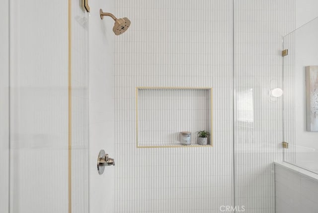 bathroom with tiled shower