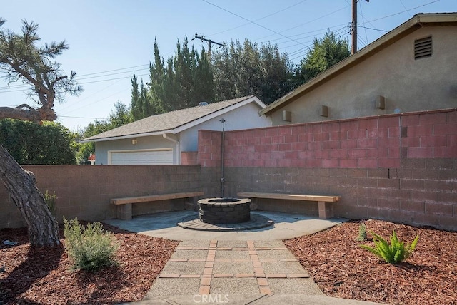 view of patio / terrace featuring an outdoor fire pit