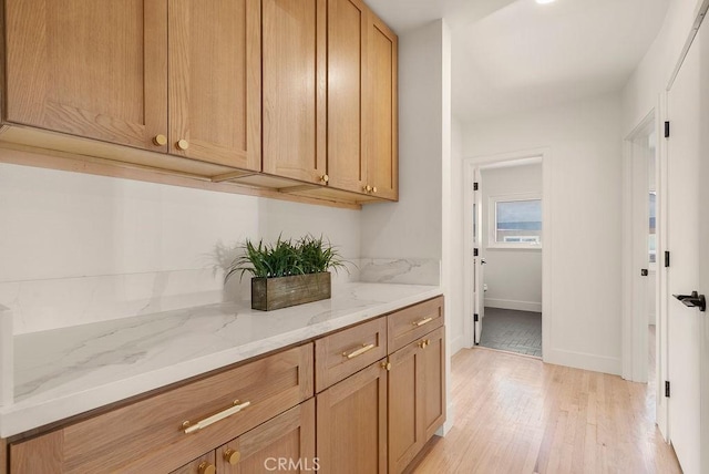 interior space featuring light stone counters and light hardwood / wood-style flooring