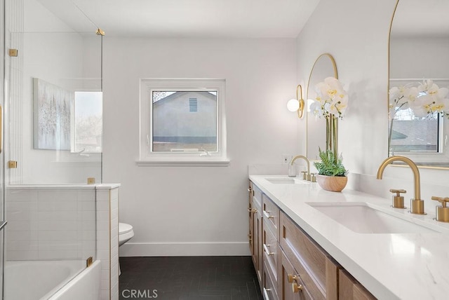 bathroom with a bathtub, toilet, and vanity