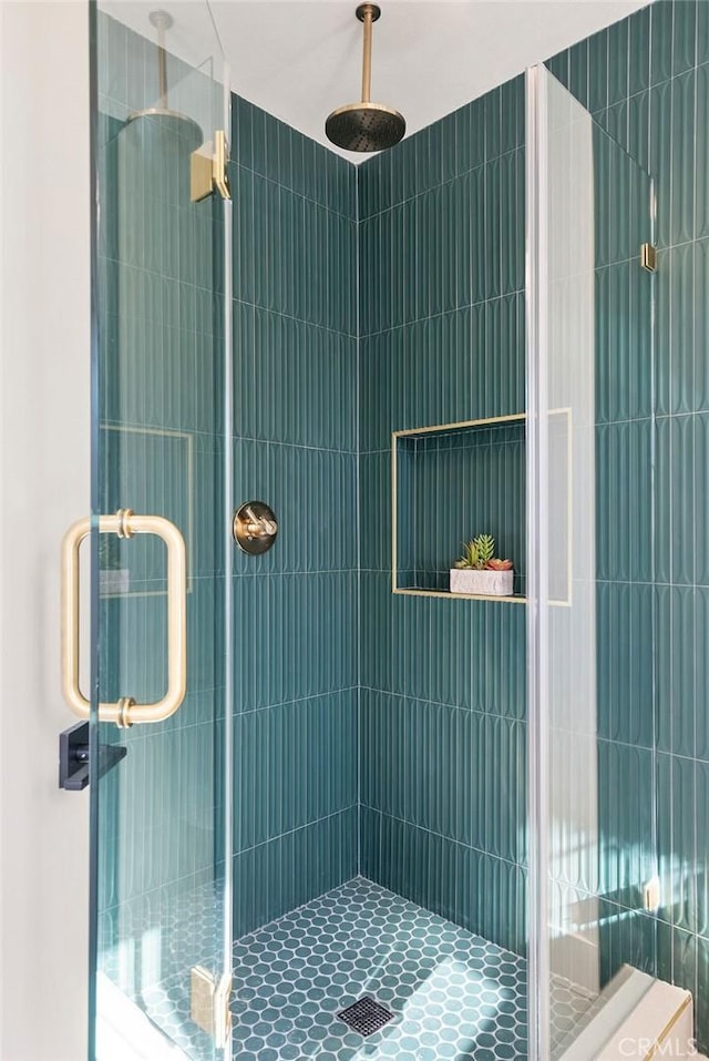 bathroom featuring a shower with door