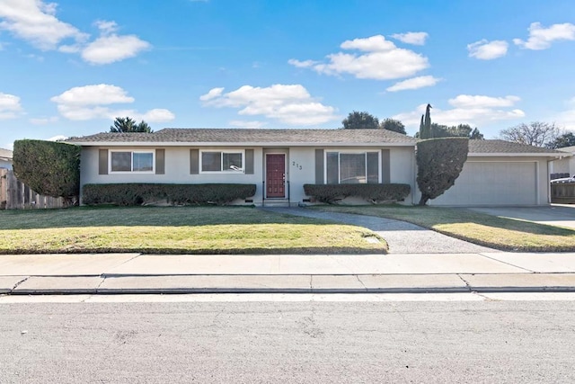 single story home with a garage and a front yard