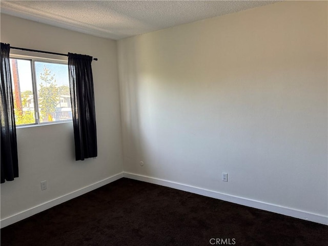 unfurnished room featuring a textured ceiling