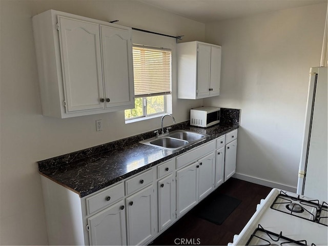 kitchen featuring white cabinets, dark hardwood / wood-style floors, and sink