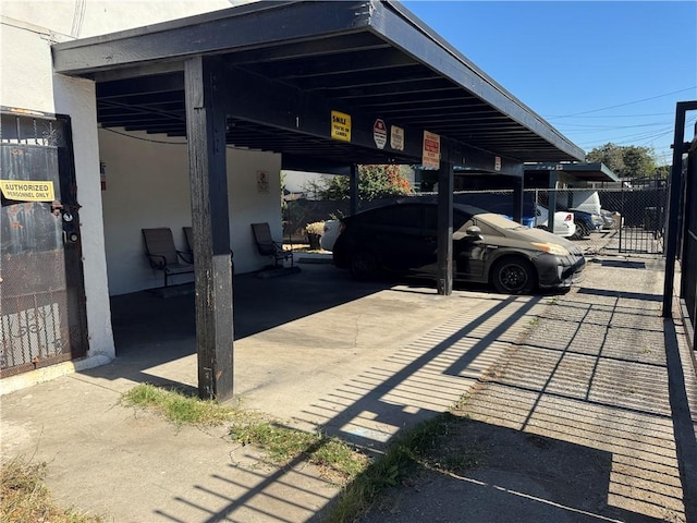 view of parking / parking lot featuring a carport