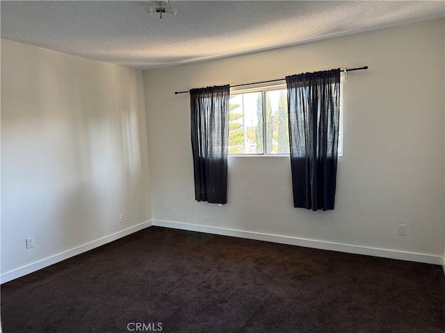 carpeted spare room with a textured ceiling