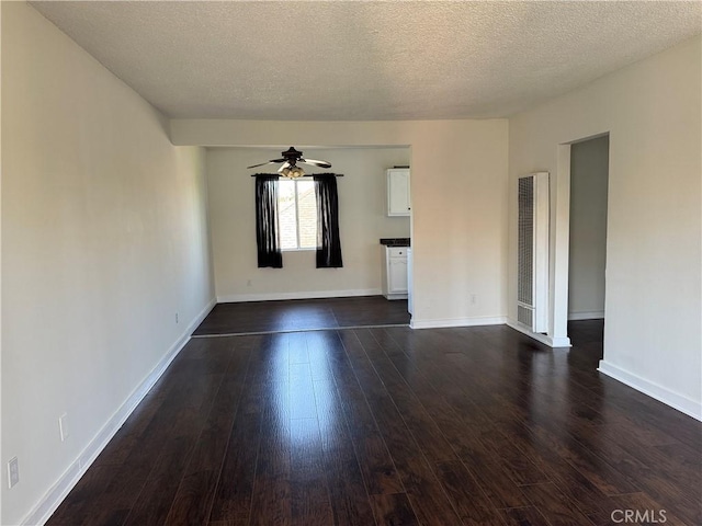 unfurnished room featuring ceiling fan, dark hardwood / wood-style flooring, and a textured ceiling