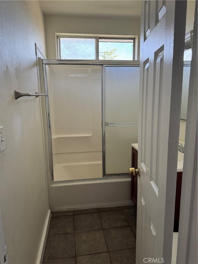 bathroom featuring combined bath / shower with glass door, vanity, and tile patterned flooring