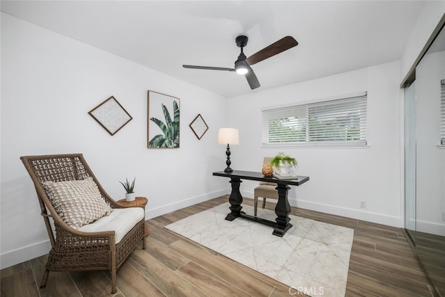 sitting room featuring ceiling fan and dark hardwood / wood-style flooring