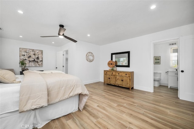 bedroom with ensuite bath, ceiling fan, and light wood-type flooring