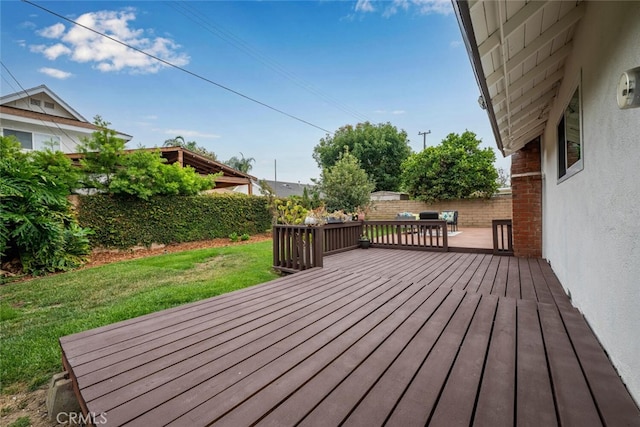 wooden deck featuring a lawn