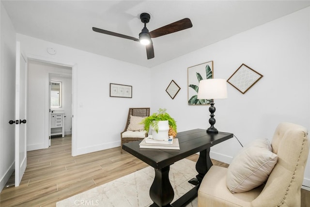 office with ceiling fan and light hardwood / wood-style flooring