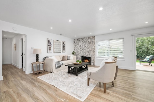 living room with a fireplace and light hardwood / wood-style floors