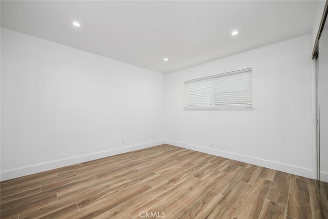 empty room with hardwood / wood-style flooring