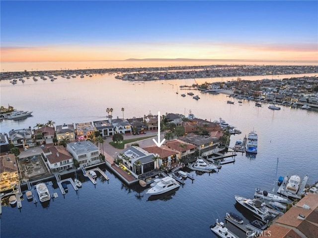 aerial view at dusk with a water view