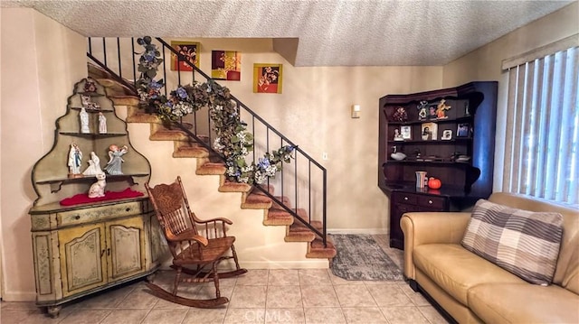 living room with a textured ceiling and light tile patterned floors