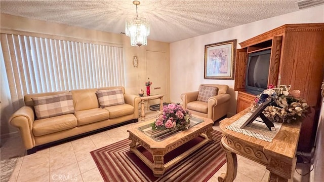 living room featuring an inviting chandelier, a textured ceiling, and light tile patterned floors