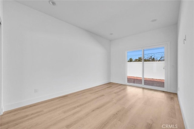 unfurnished room with light hardwood / wood-style flooring