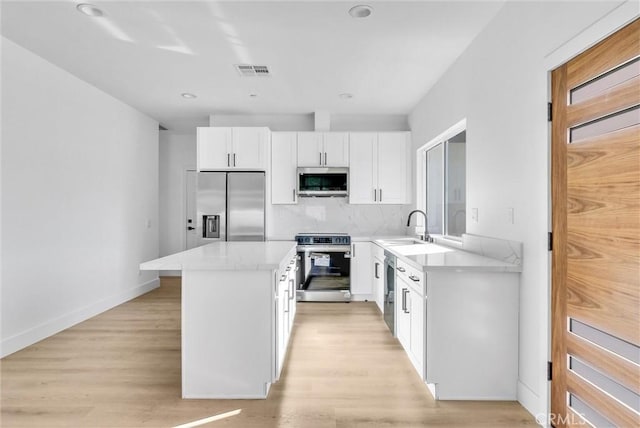 kitchen featuring light hardwood / wood-style floors, sink, white cabinetry, and stainless steel appliances