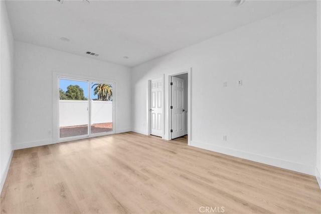 empty room with light hardwood / wood-style flooring