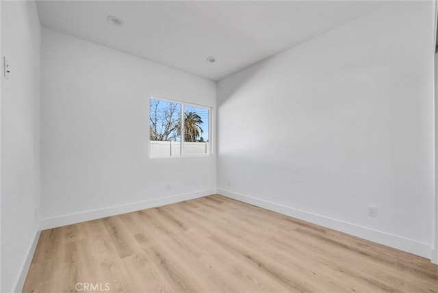 unfurnished room with light wood-type flooring