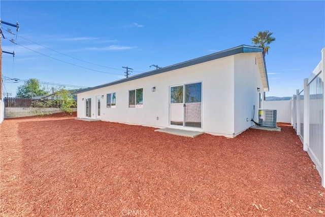 rear view of house featuring central AC unit