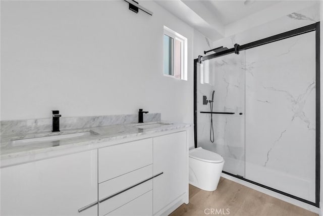 bathroom featuring hardwood / wood-style flooring, vanity, toilet, and walk in shower