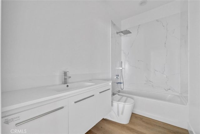 bathroom featuring shower / bath combination, vanity, toilet, and wood finished floors