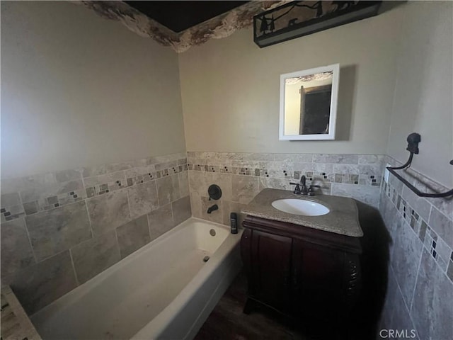 bathroom featuring vanity and a bath