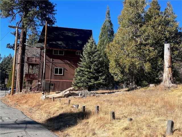 view of property exterior with a wooden deck