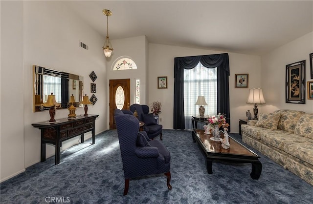 carpeted living area with high vaulted ceiling and visible vents