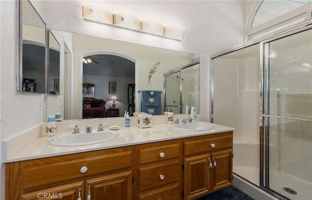 full bathroom featuring a sink, connected bathroom, a shower stall, and a ceiling fan