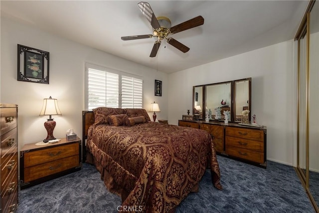 bedroom featuring dark carpet and ceiling fan