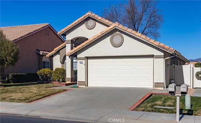 view of front of house with concrete driveway, stucco siding, an attached garage, a tile roof, and fence