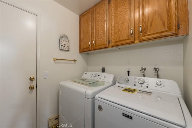 laundry area featuring washing machine and dryer and cabinet space