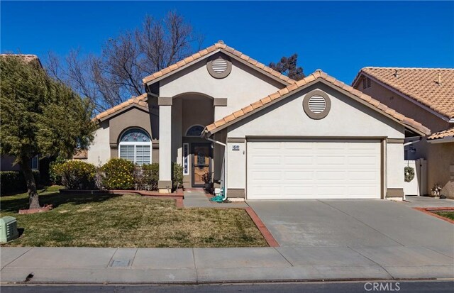 view of front of home with a garage and a front lawn