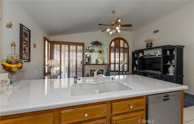 kitchen with visible vents, dishwasher, a sink, ceiling fan, and brown cabinets