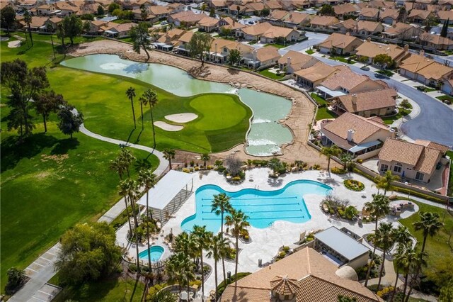 birds eye view of property with a residential view, view of golf course, and a water view