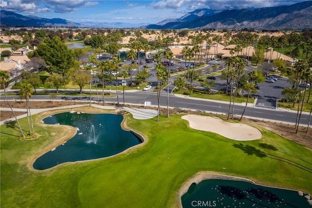 drone / aerial view with a mountain view and golf course view